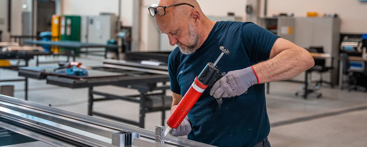 Fabricator preparing aluminium profiles in the workshop.